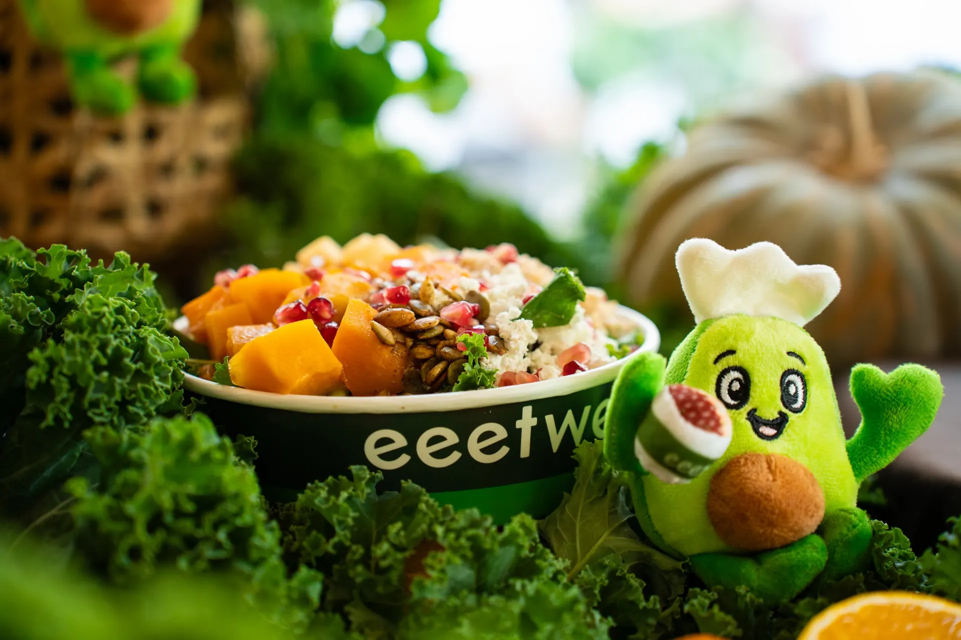 eeetwell butternut squash bowl next to the brand mascot