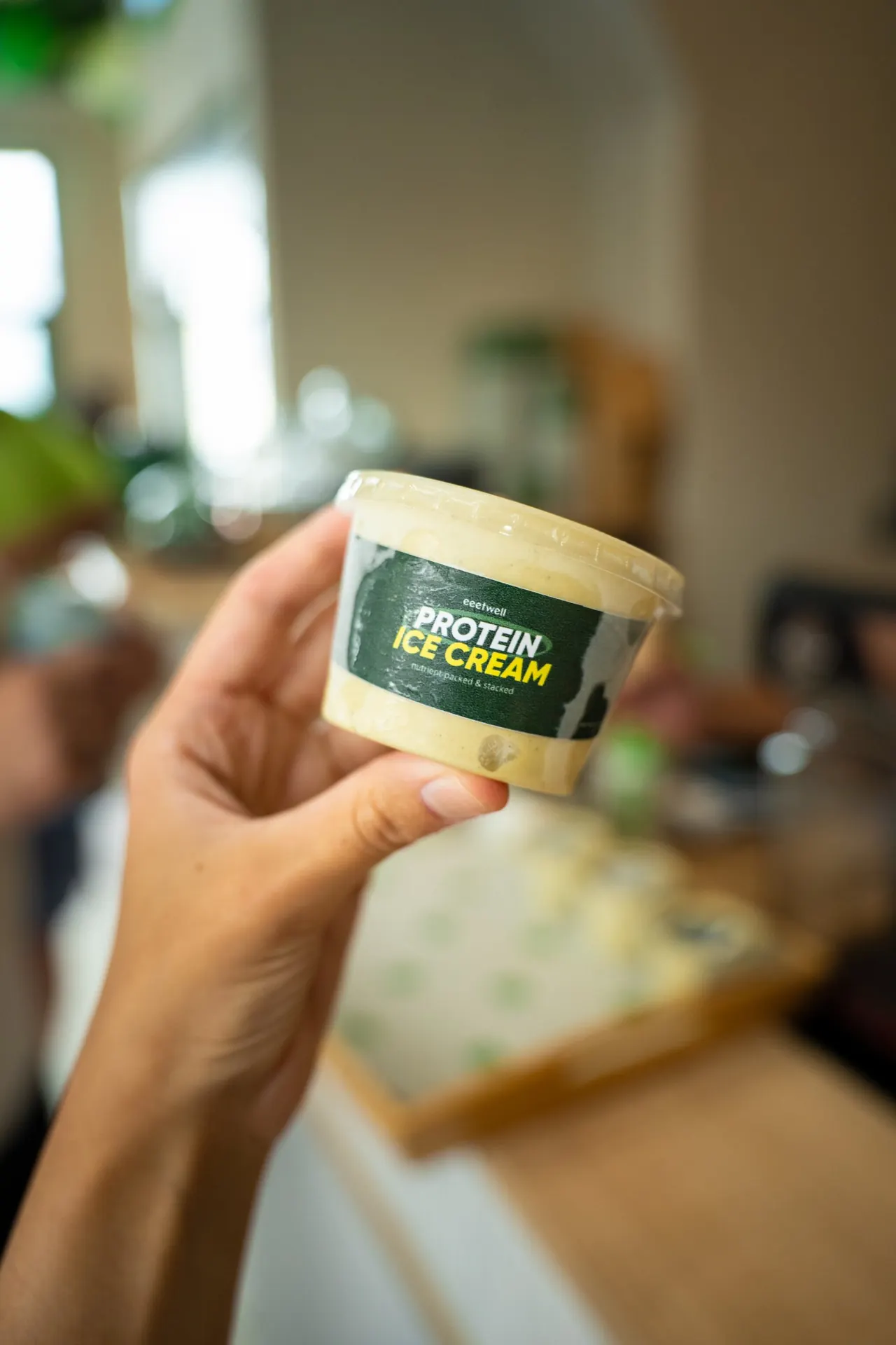Hand holding an eeetwell protein ice cream