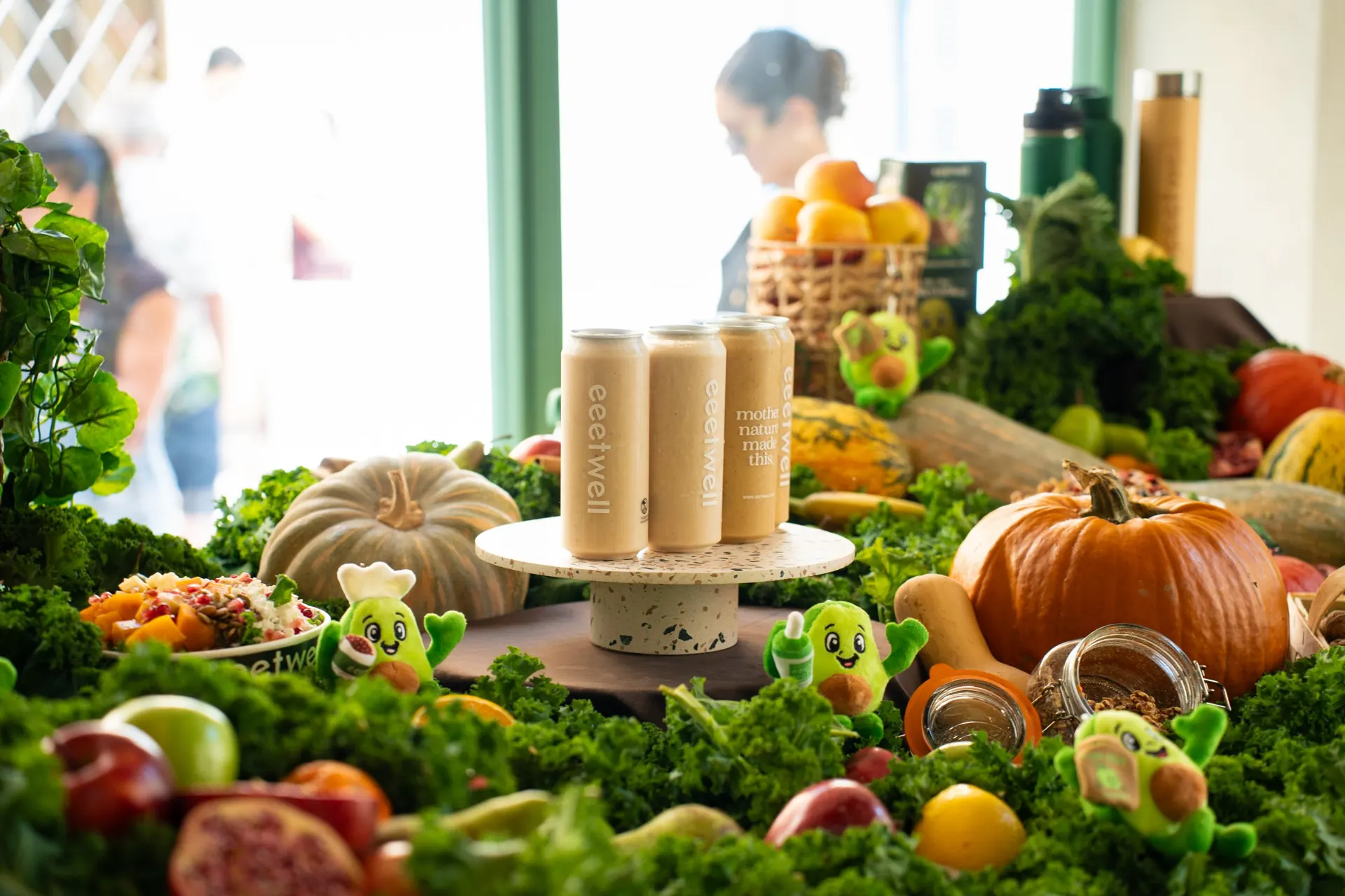 eeetwell smoothie cans displayed among pumpkins and produce